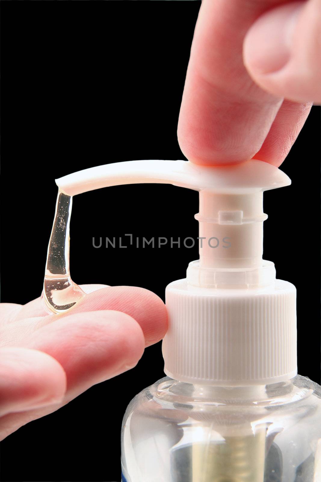 Man helping himself to a dollop of antibacterial soap, close up of hands