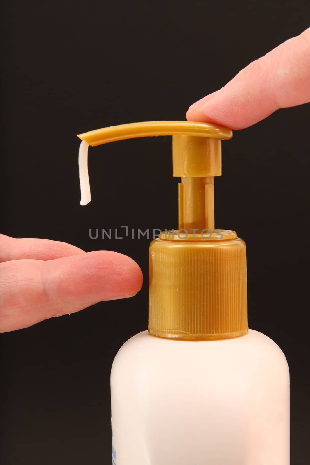Close up of man dispensing hand lotion from bottle