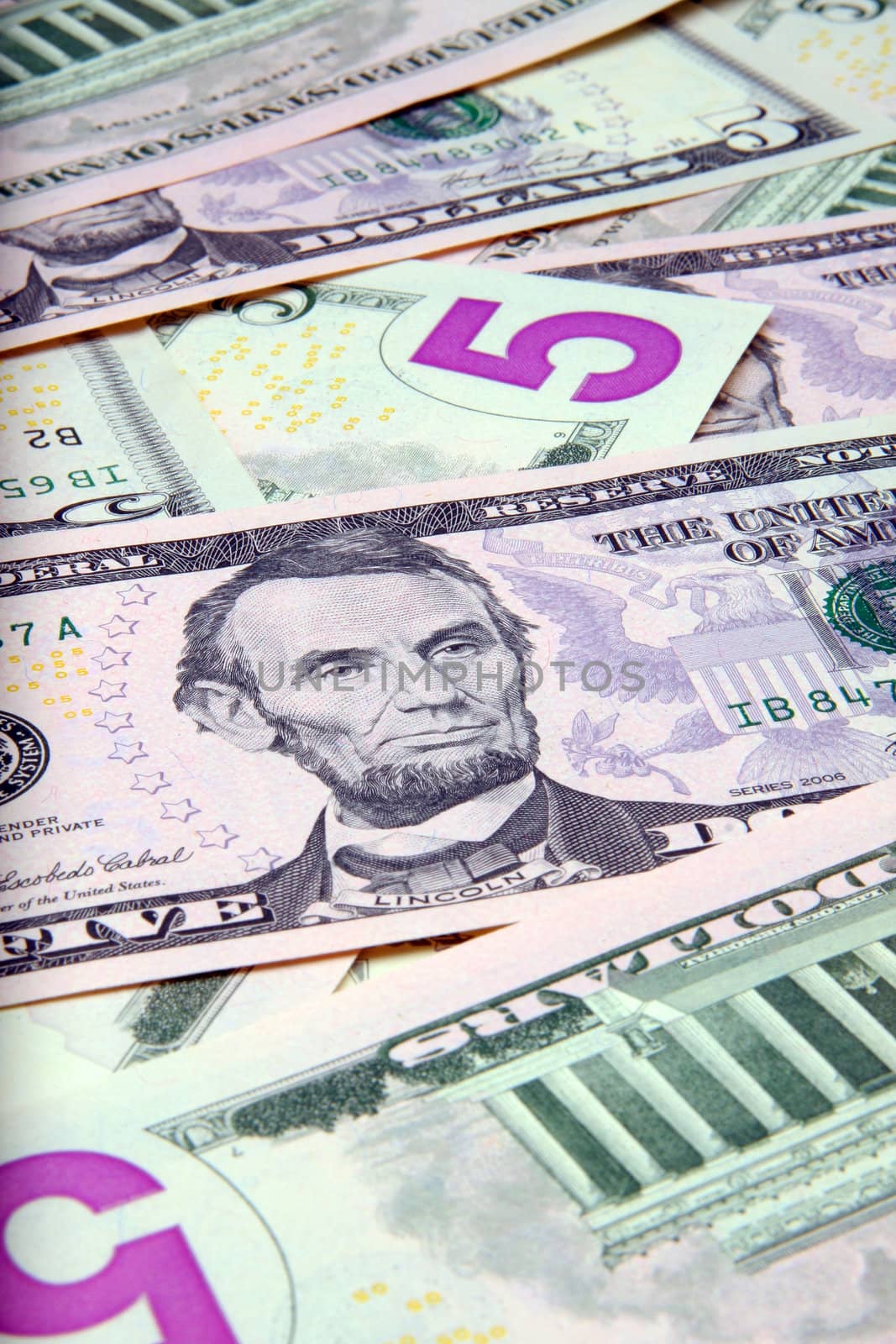 Pile of US $5 bills - new fives