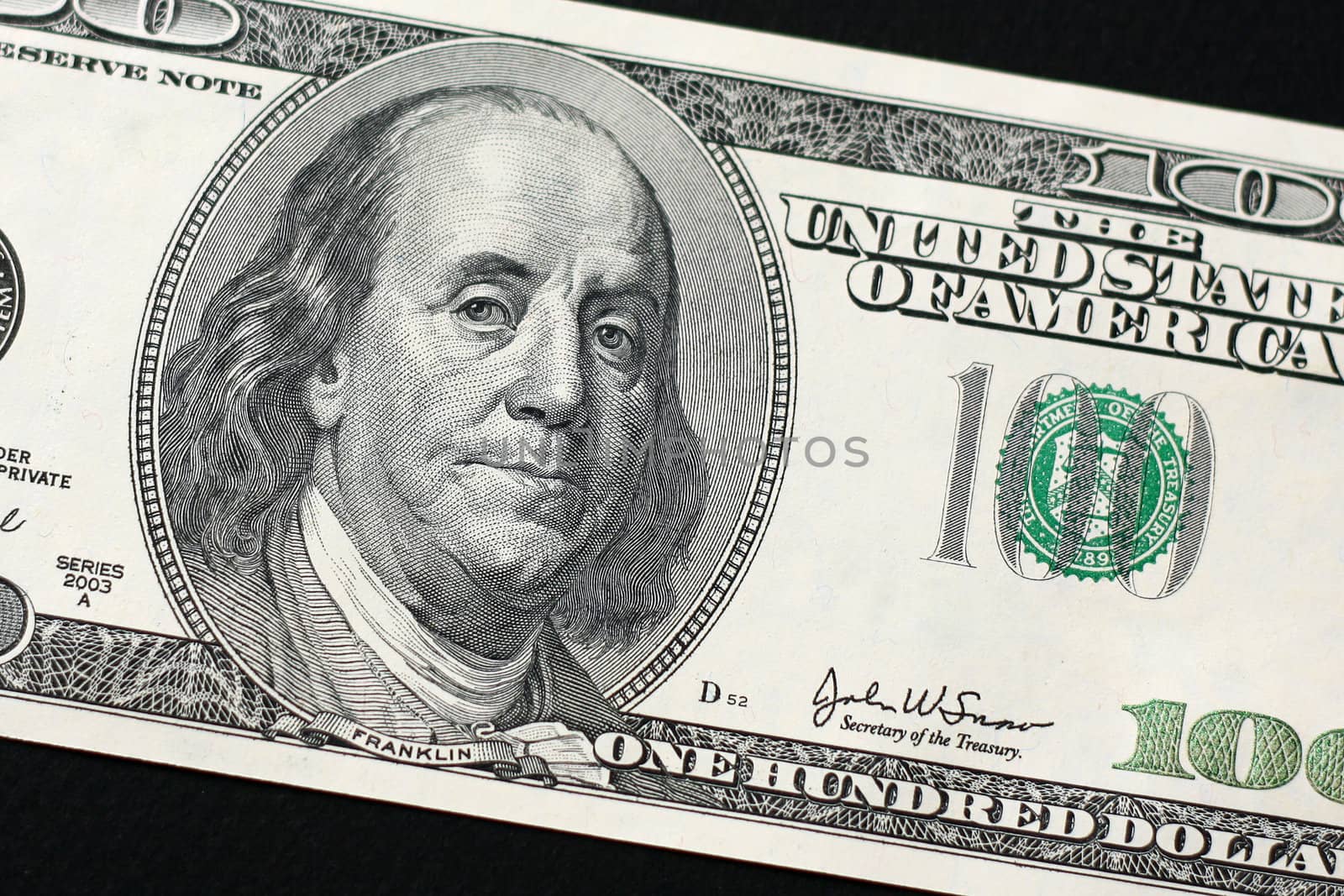 US $100 bill isolated on black background by svanblar