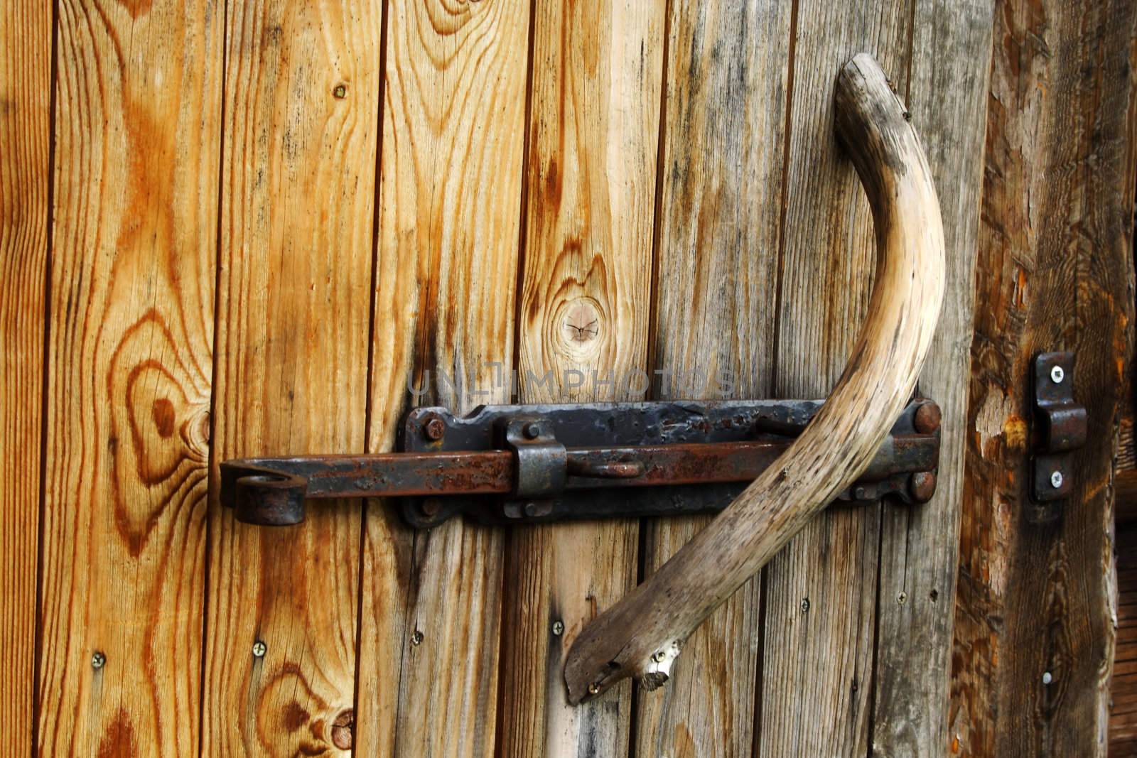 Foto of metal doorknob on old wood door