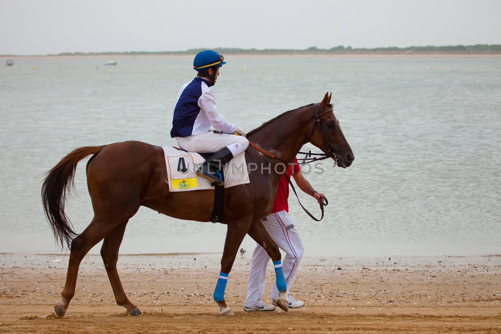 SANLUCAR DE BARRAMEDA, CADIZ, SPAIN - AUGUST 07: Unknown rider at the start of the horses races of the beach of Sanlucar de Barrameda on August 07, 2010 in Sanlucar de Barrameda, Cadiz, Spain.