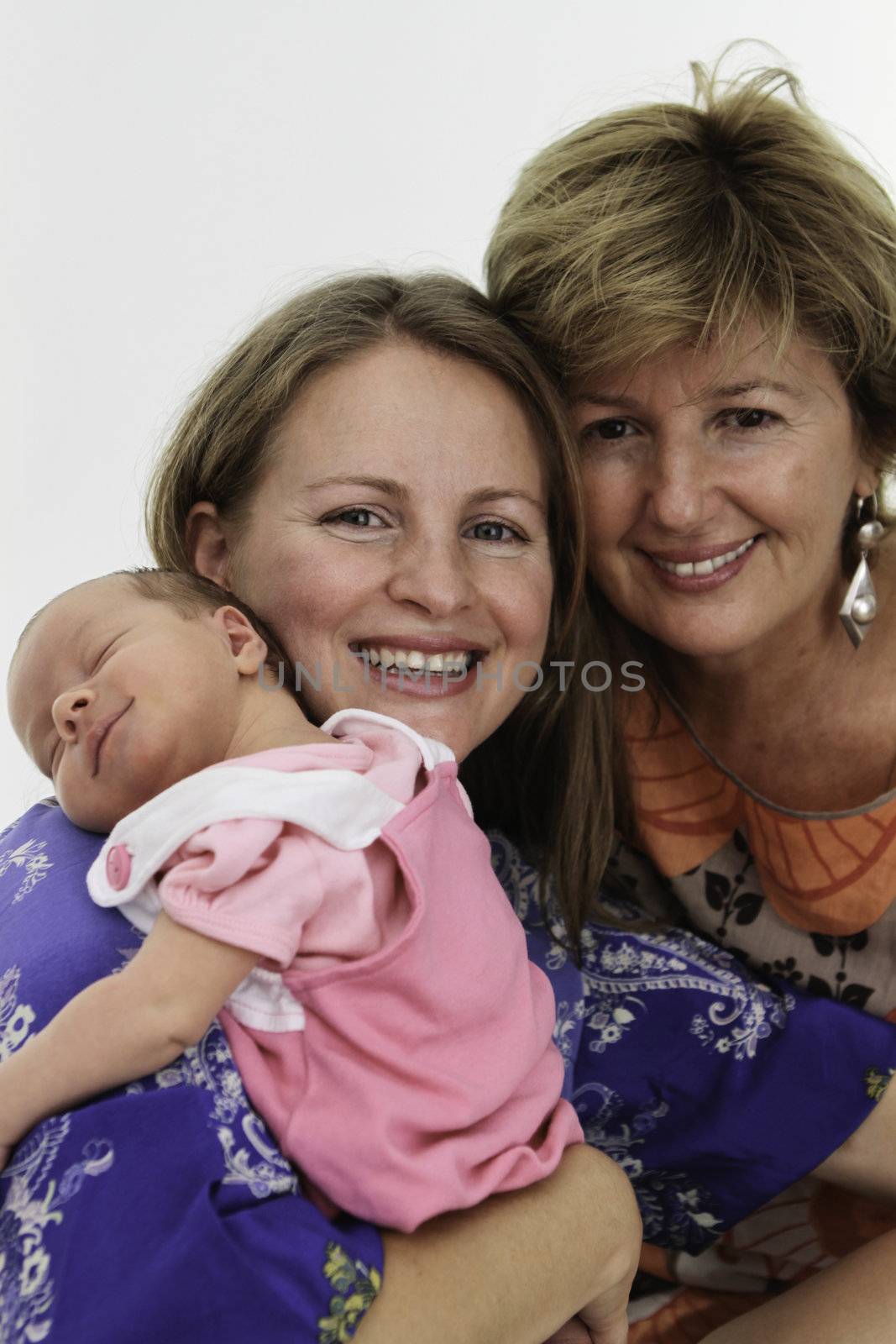 Females of three generations, Grandmother Mother and daughter all together smiling front of the white background