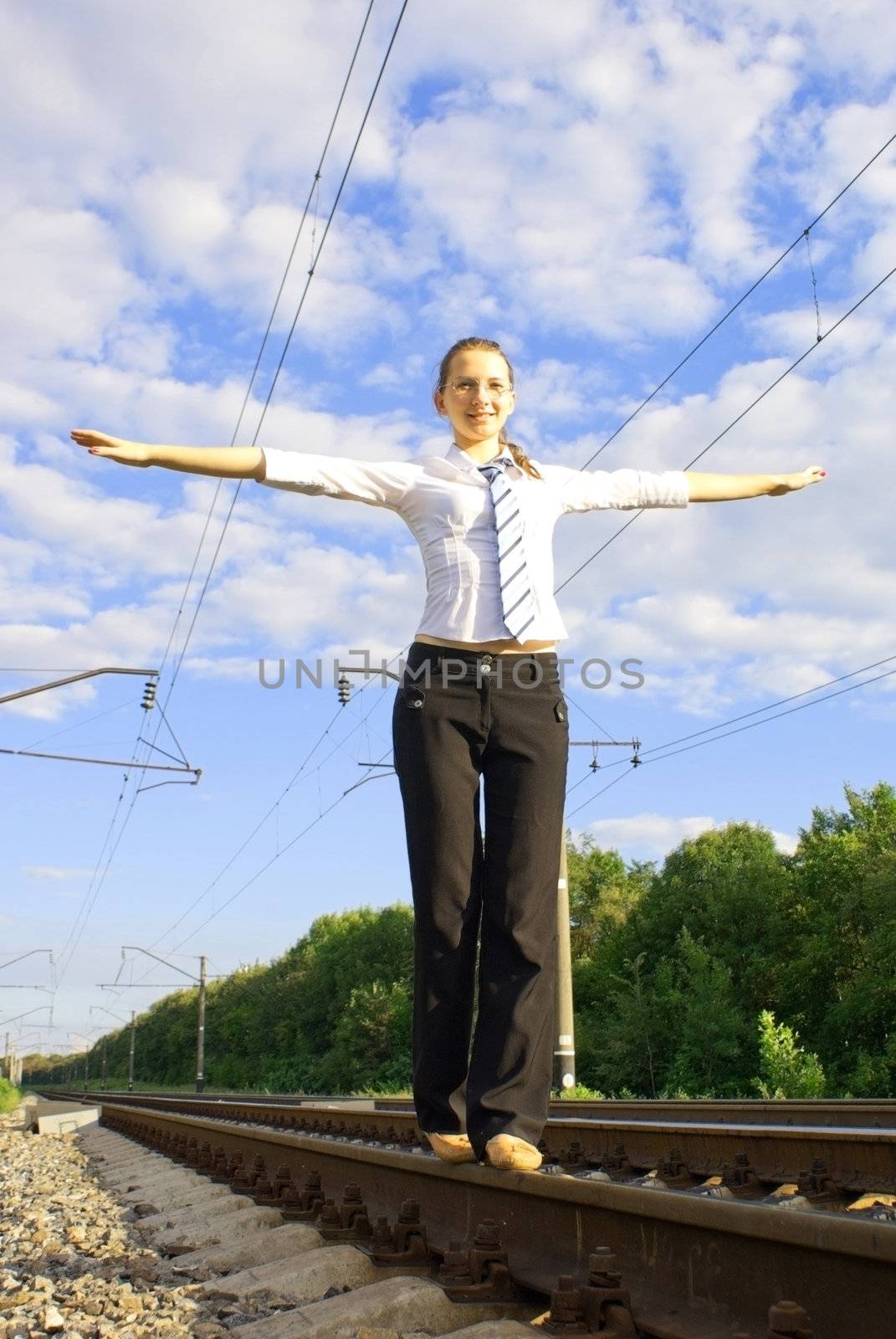 Young lady balancing on the rail road track by AndreyKr