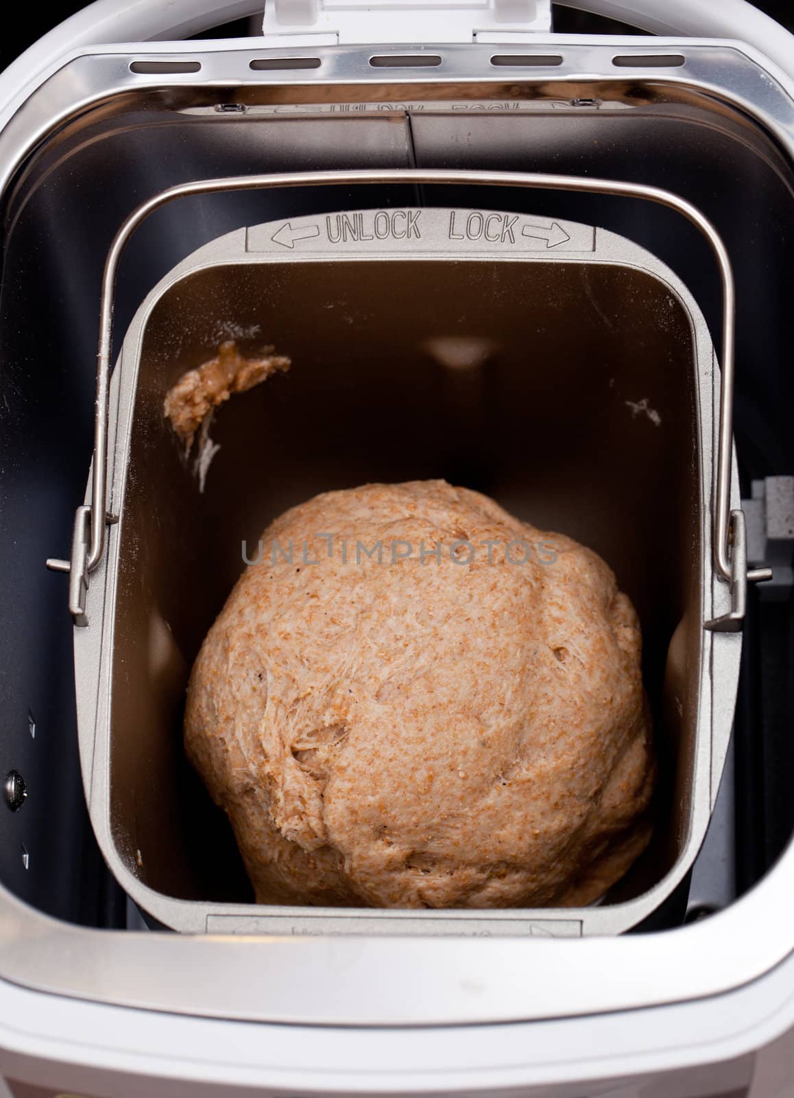 Bread making machine with dough starting to rise with the yeast