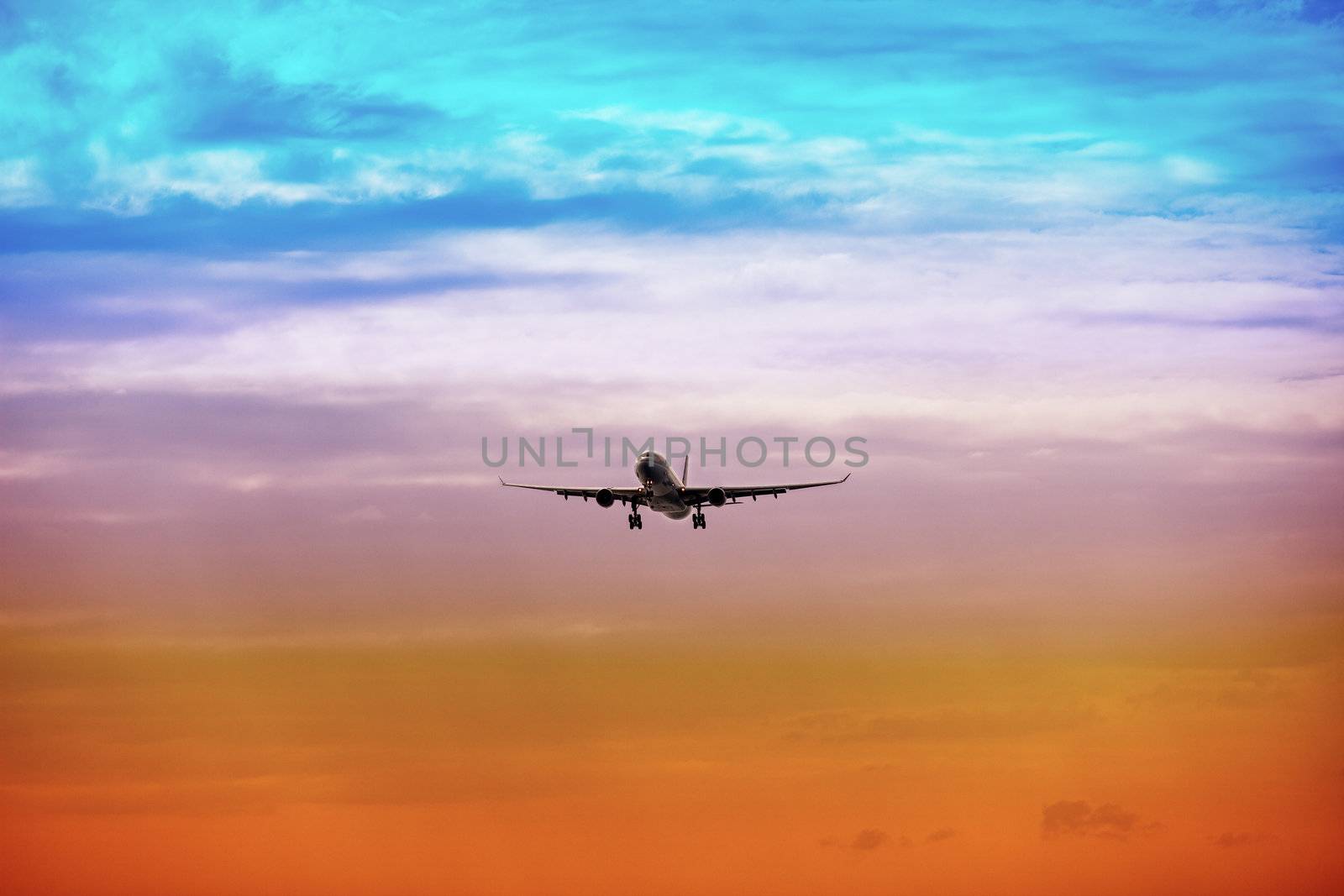 A passenger plane takes off at bright sunset