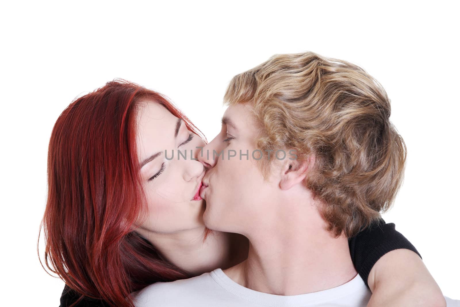 Portrait of young caucasian couple kissing. by BDS