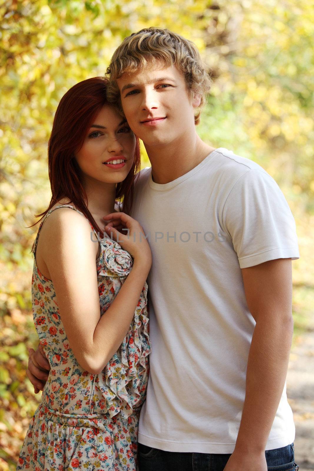 Portrait of young caucasian couple standing on stroll.