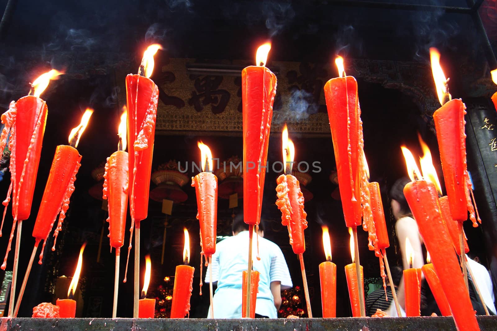 Joss sticks and red candles burning at a Chinese temple