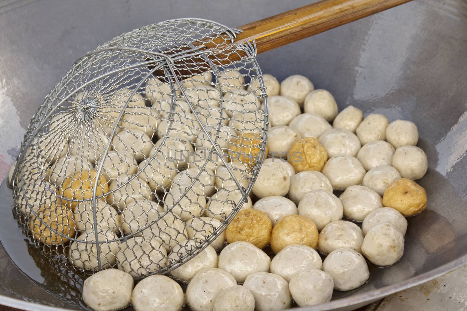 Fish meat ball fry in pan at market of Thailand