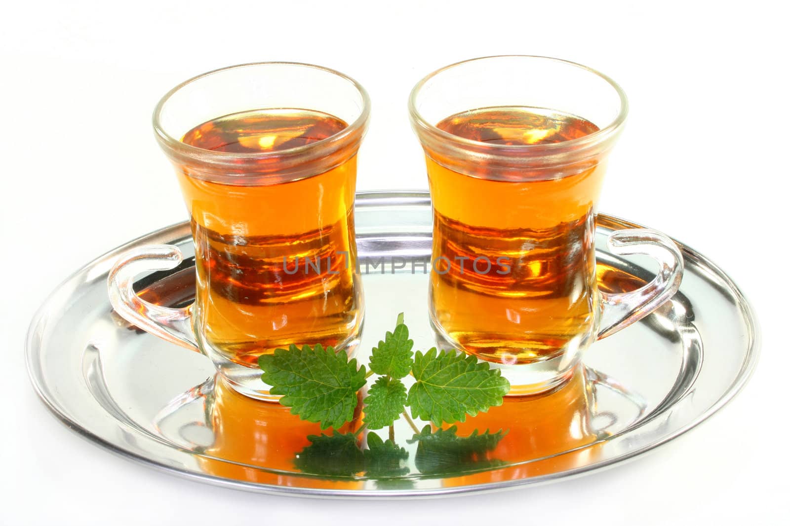 two glasses of orange tea and fresh orange and lemon