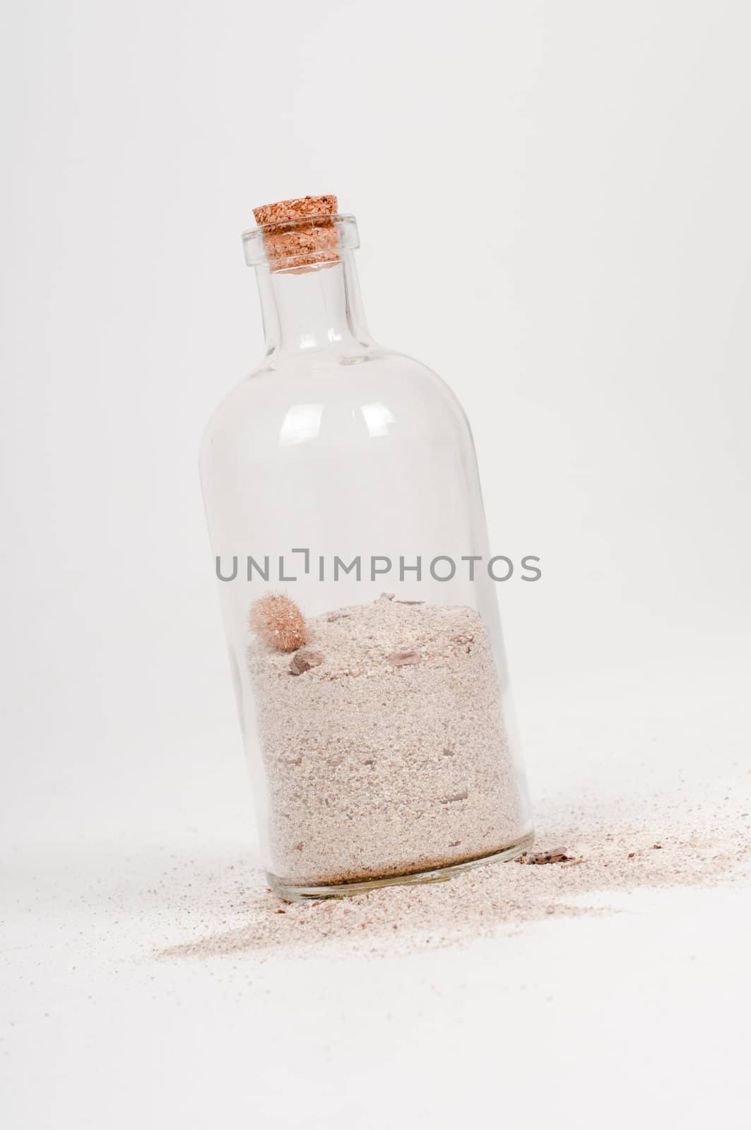 Shot of bottle with sand on light background