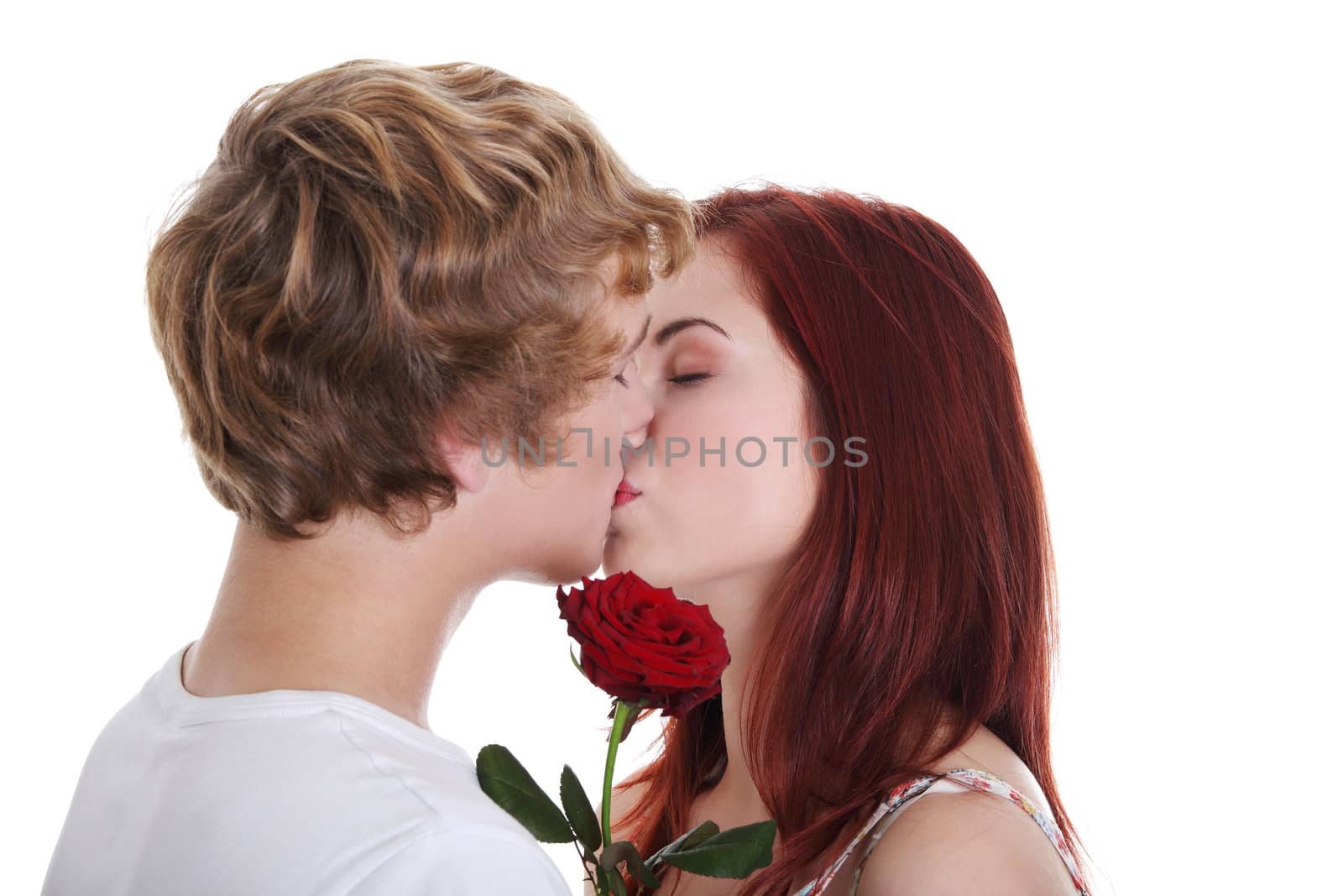 Kissing caucasian couple with rose, isolated on white background.