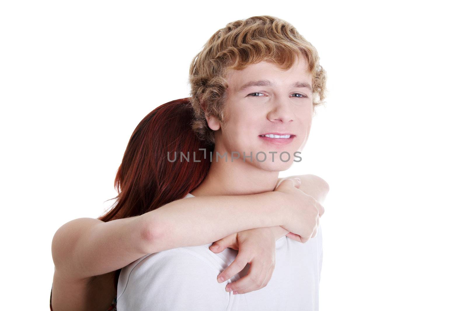 Young caucasian couple embracing against white background.