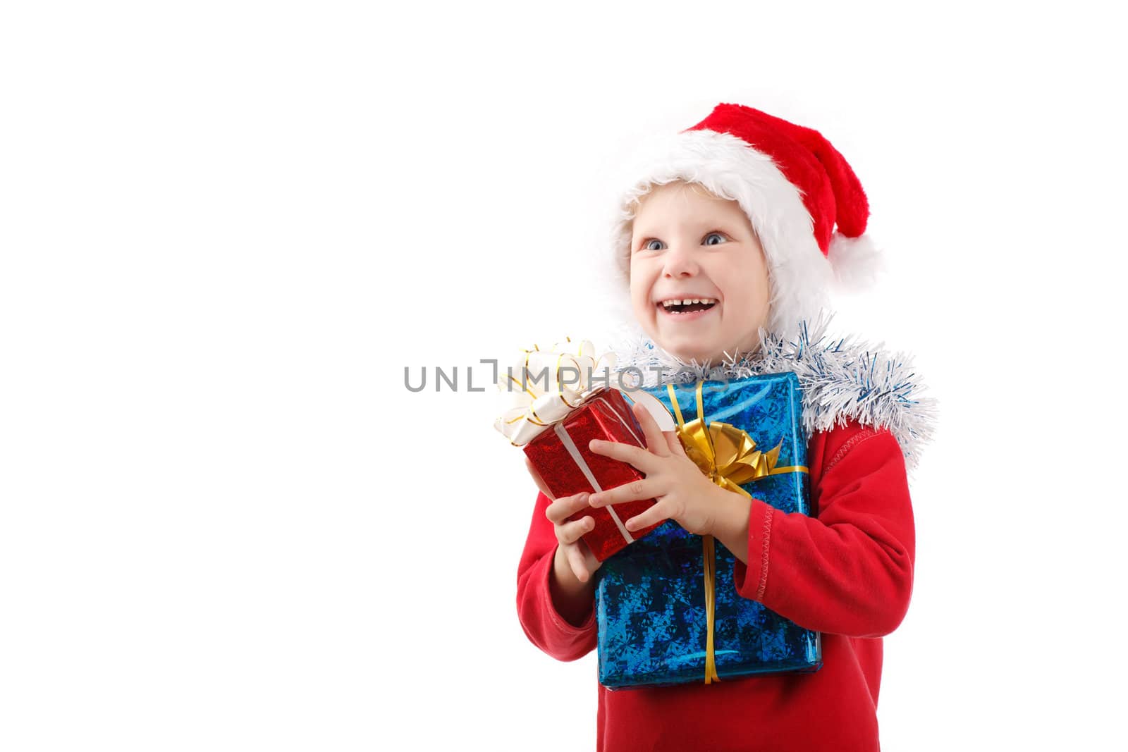 child in Santas cap with present looking up
