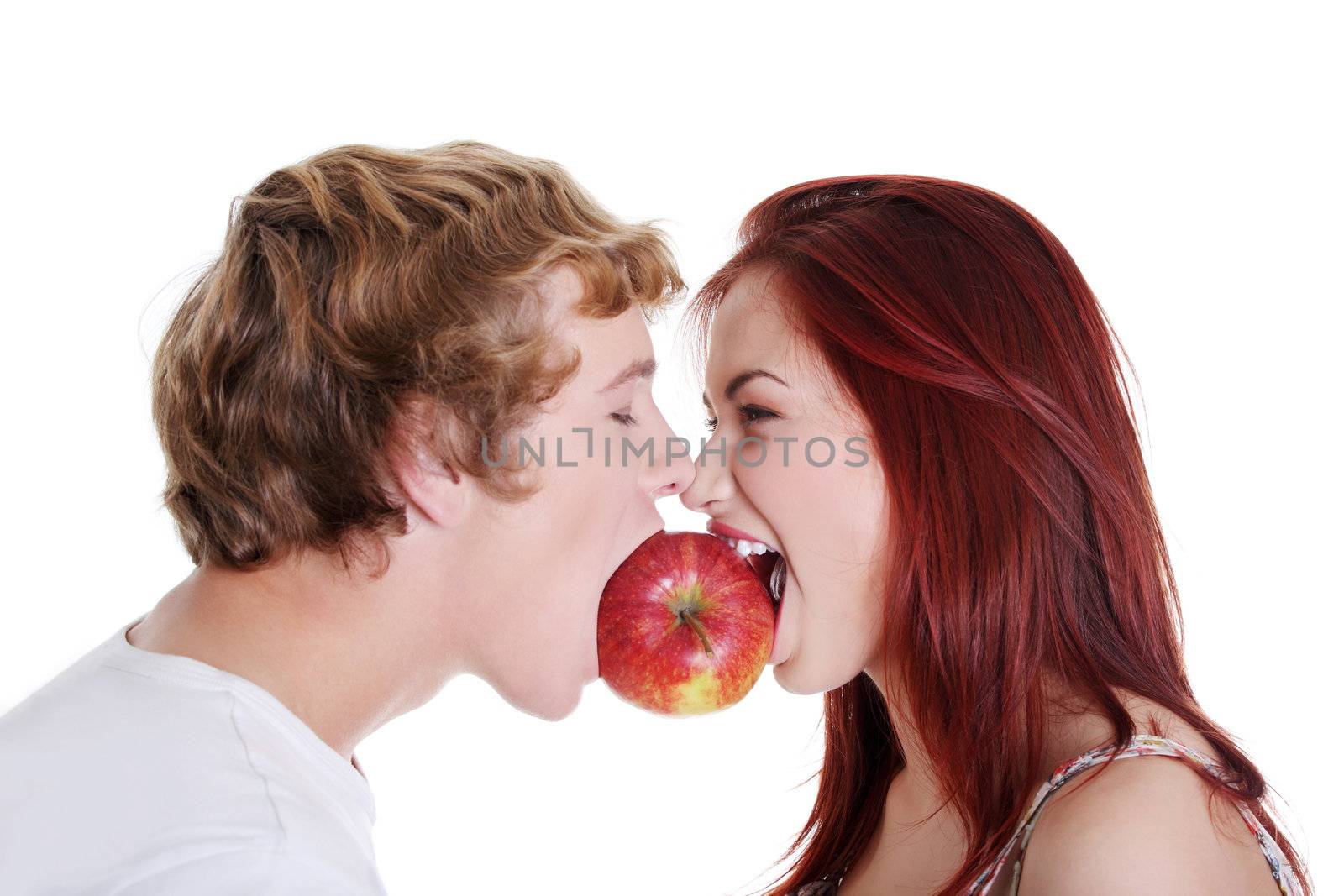 Couple biting one apple. by BDS