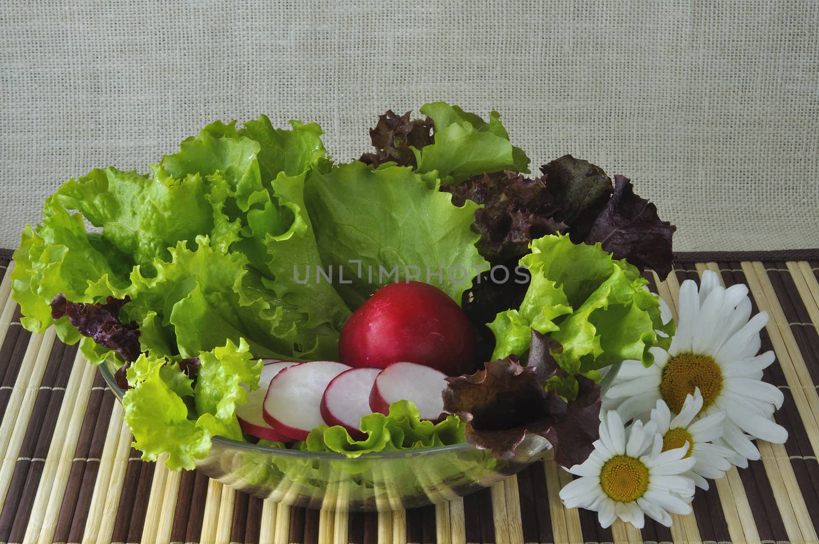 Vegetables on a glass plate and flowers
