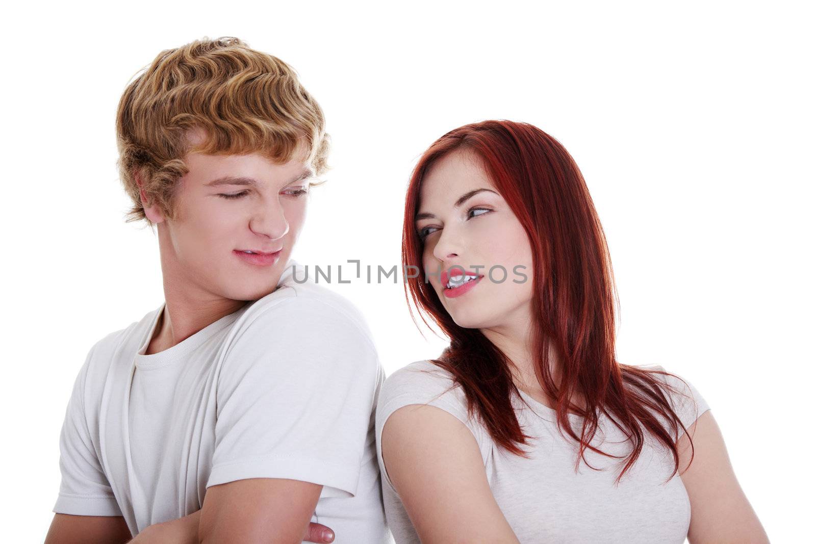 Young caucasian couple looking at each other. Isolated on white background.