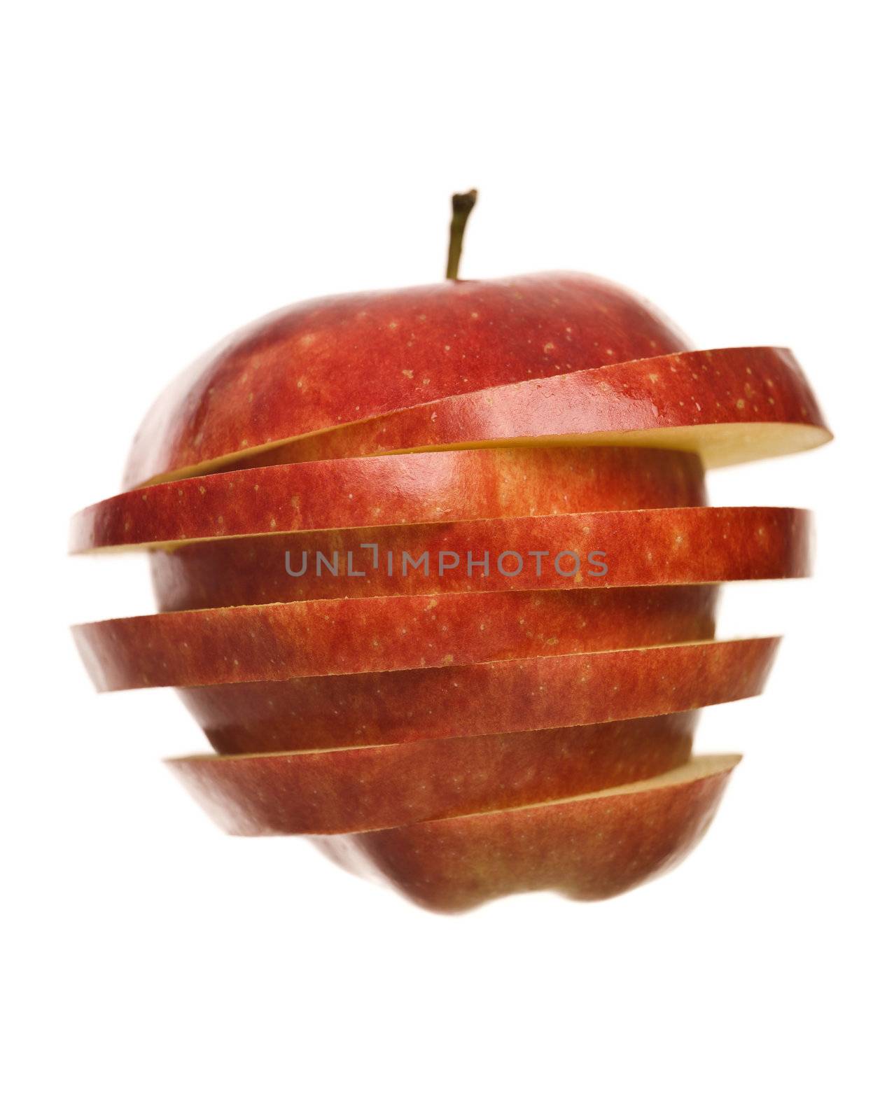 Red apple sliced in pieces isolated on white background