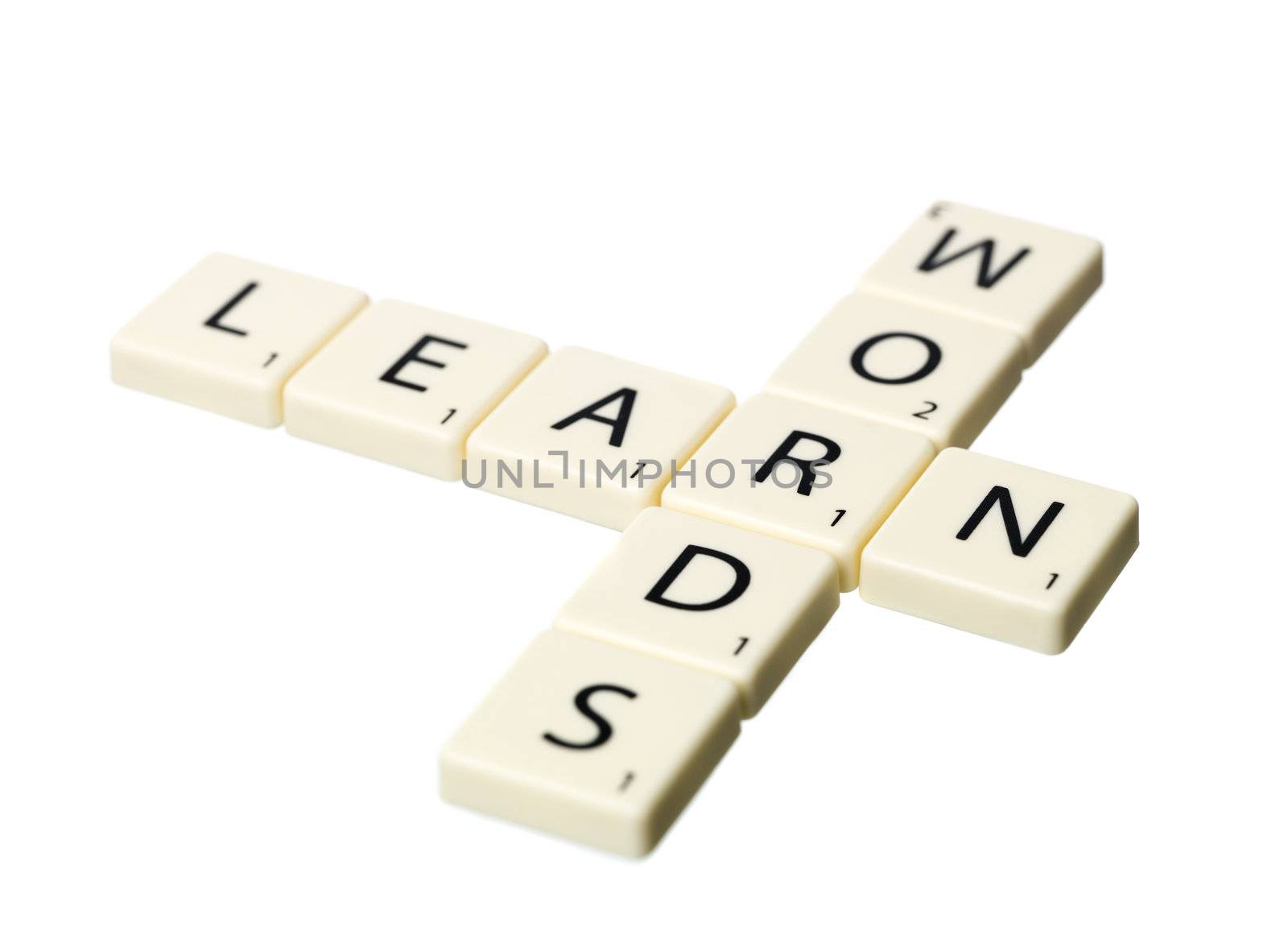 Words and Learn written by scrabble pieces isolated on white background