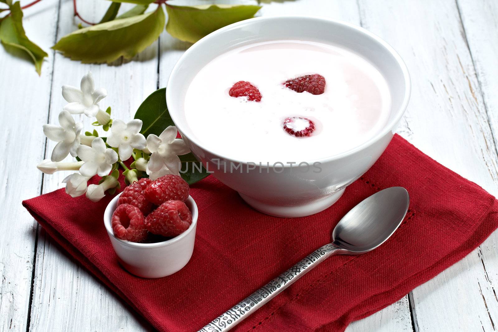 some fresh seasonal summer raspberries with yogurt