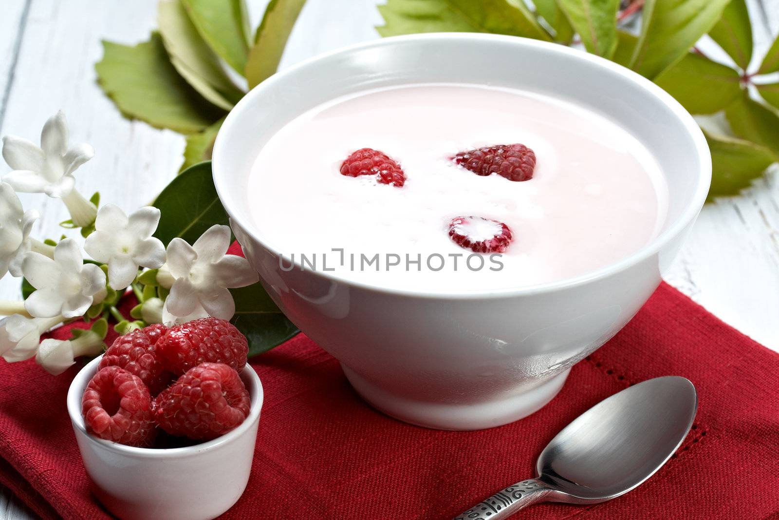 some fresh seasonal summer raspberries with yogurt