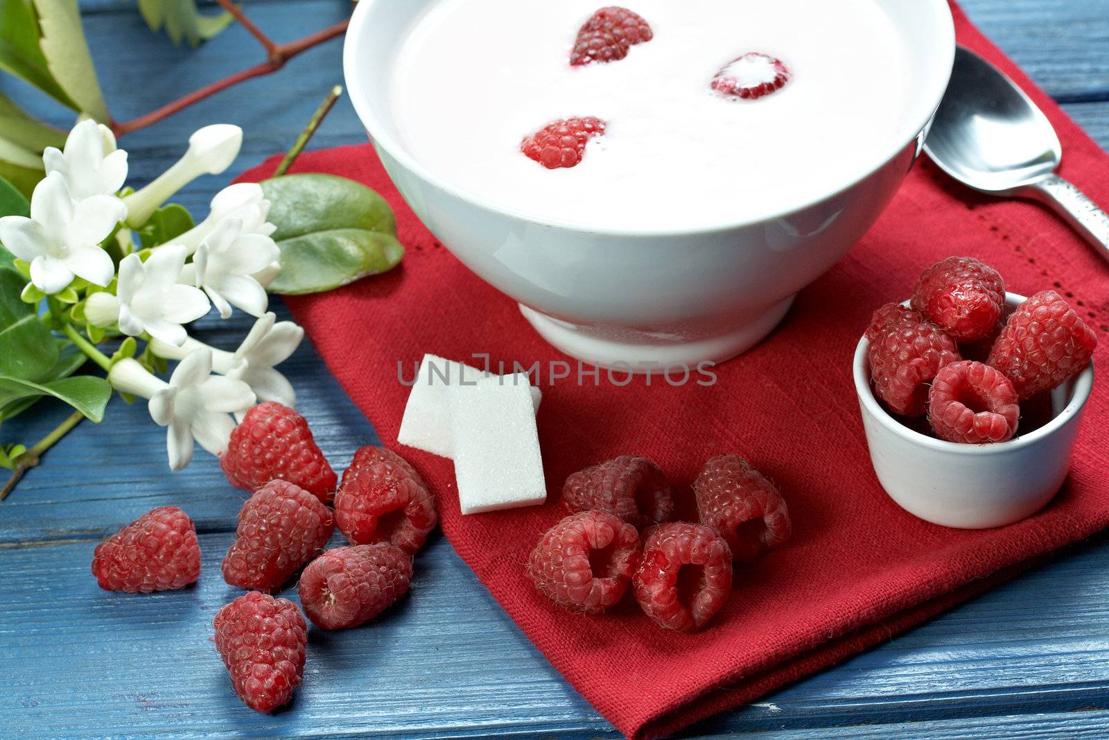 some fresh seasonal summer raspberries with yogurt