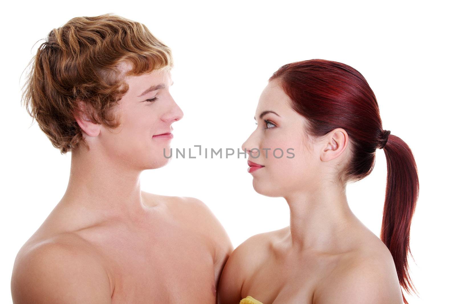 Closeup of young caucasian naked couple looking at each other.