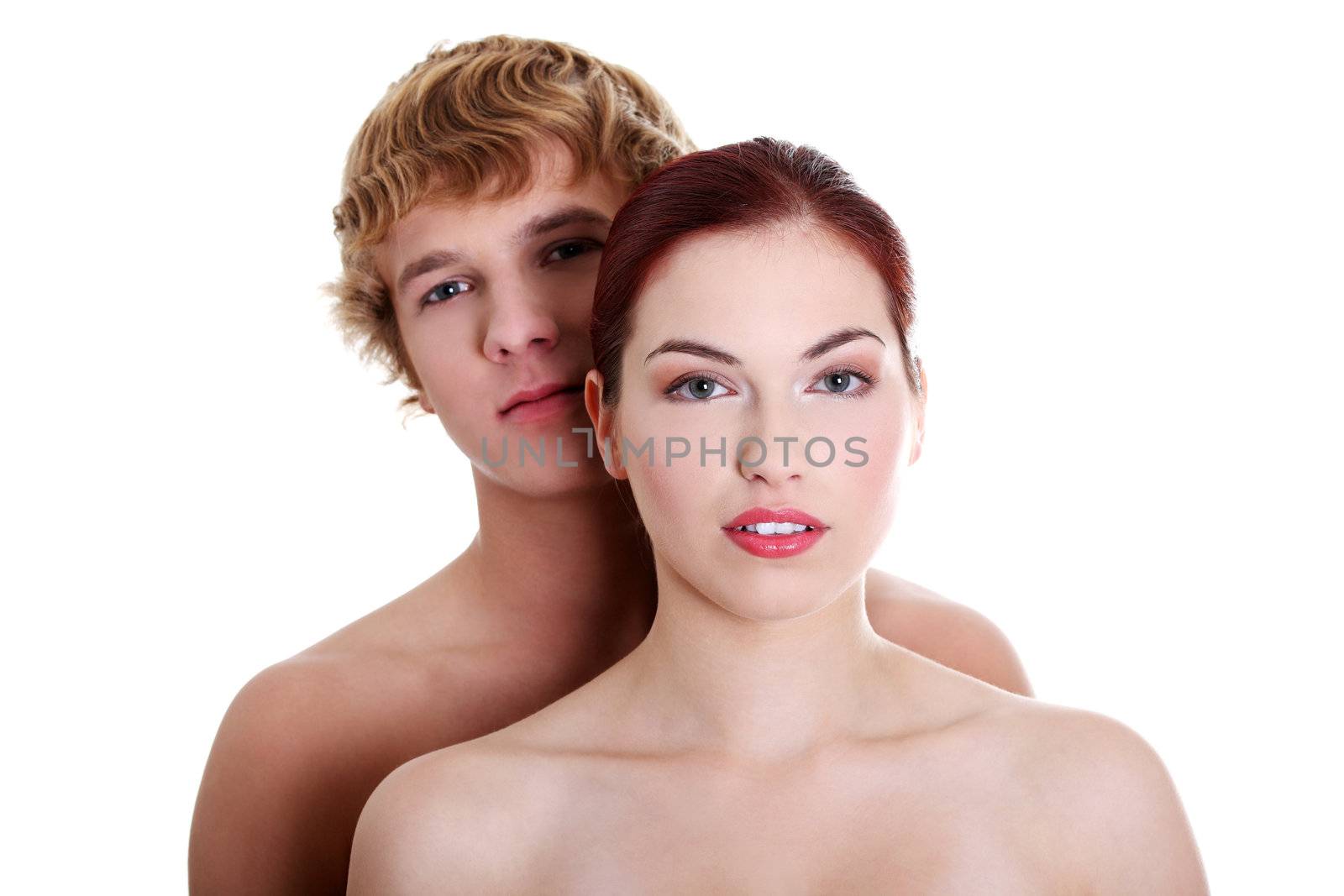 Topless couple standing against white background.