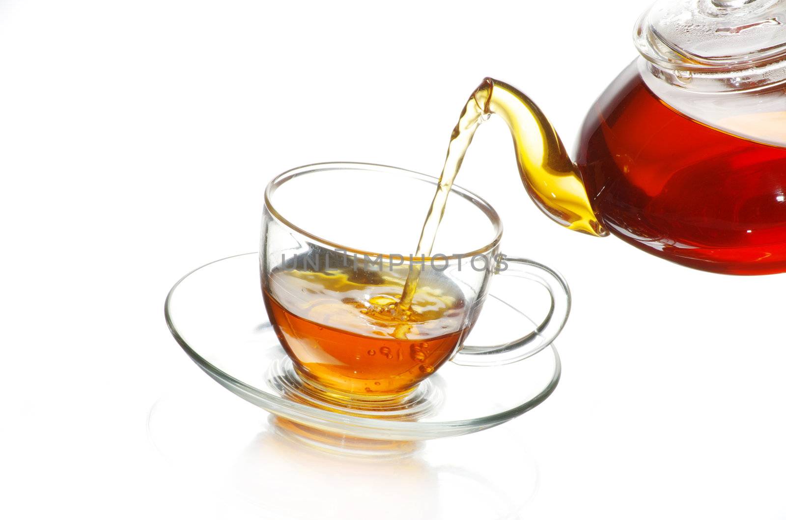 Tea being poured into glass tea cup