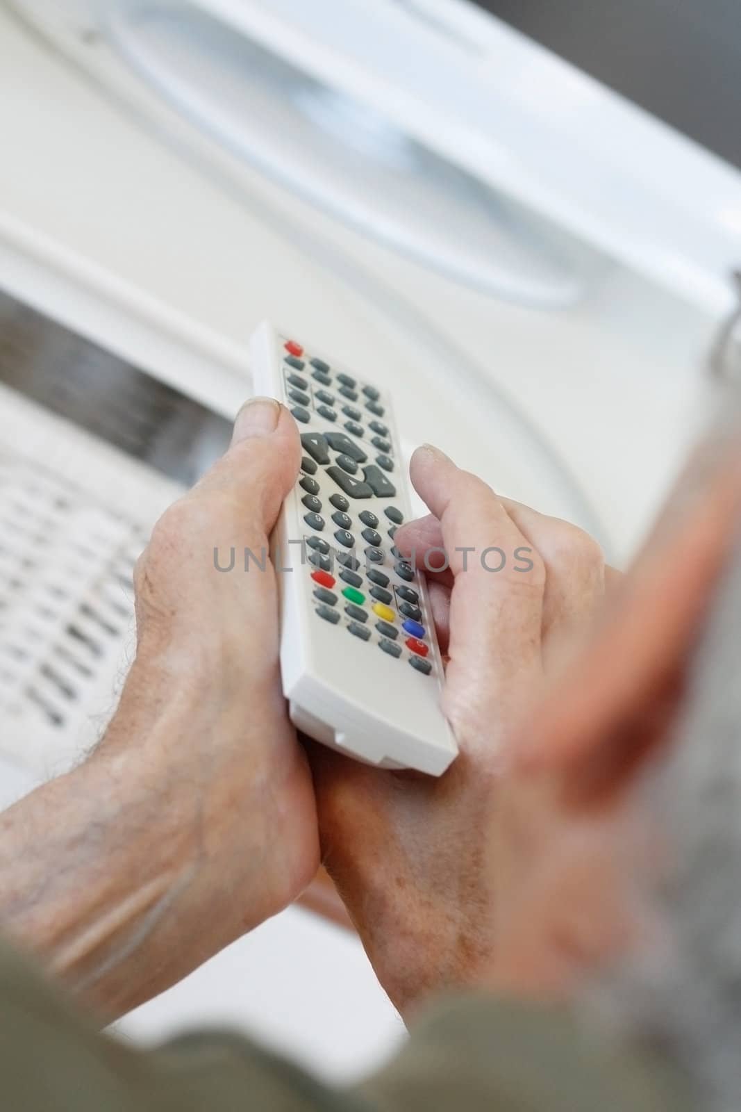 Senior man watching tv by leeser