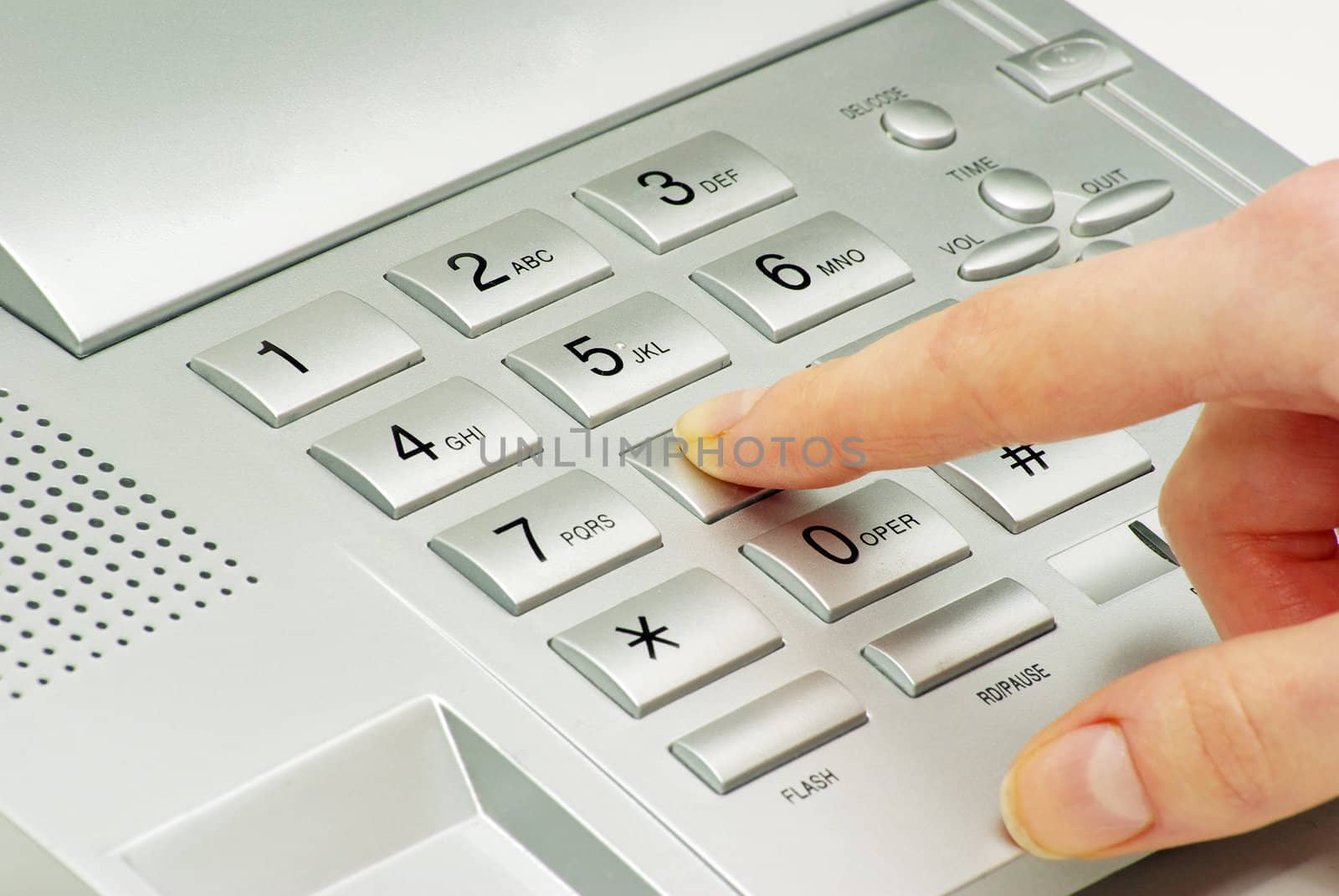 finger with  gray telephone keypad