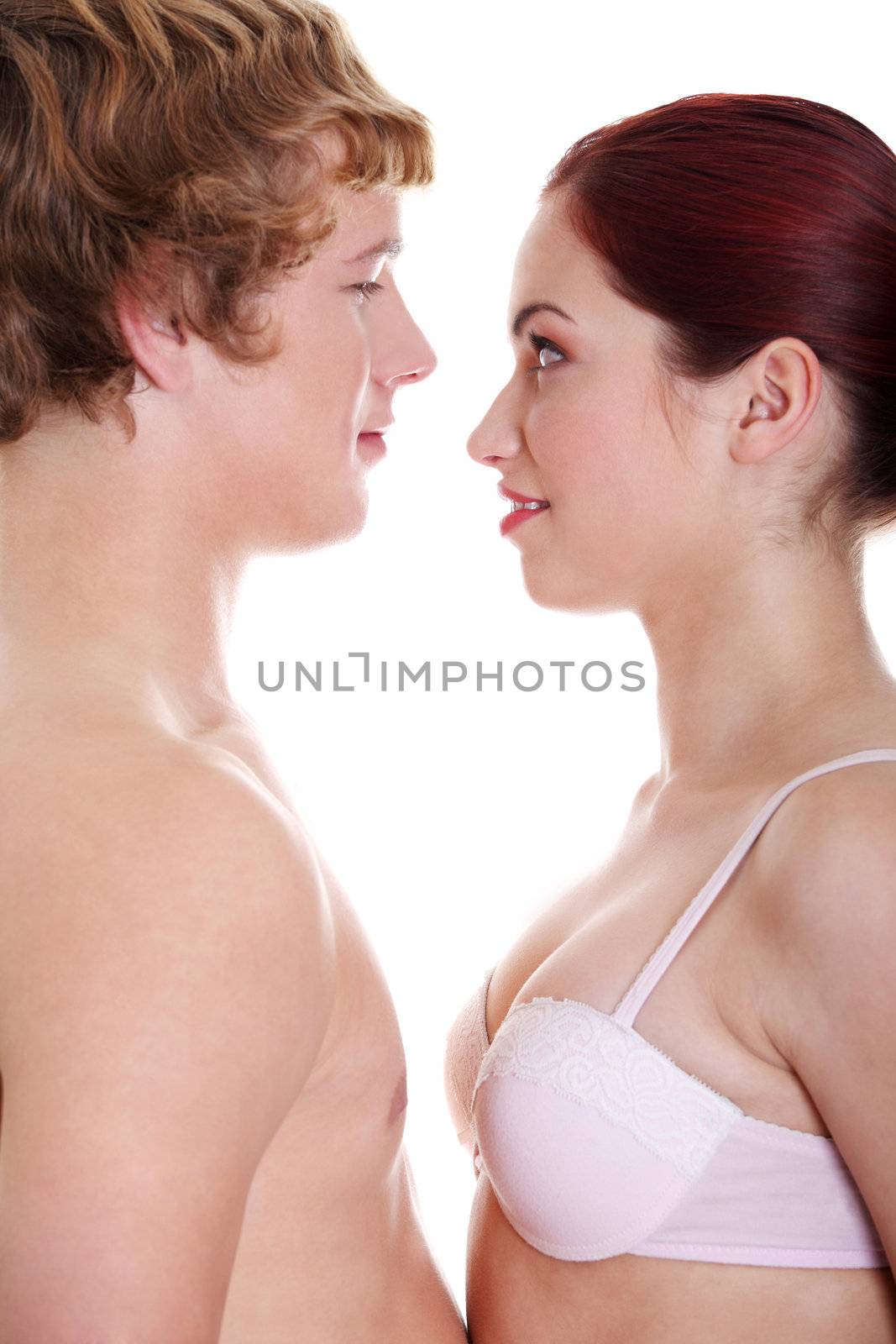 Young caucasian couple in underwear looking at each other.