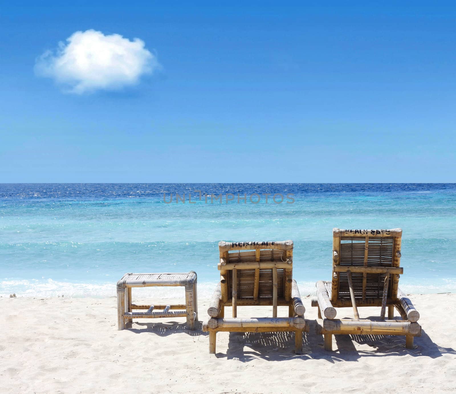 Beach chairs on beach by leeser