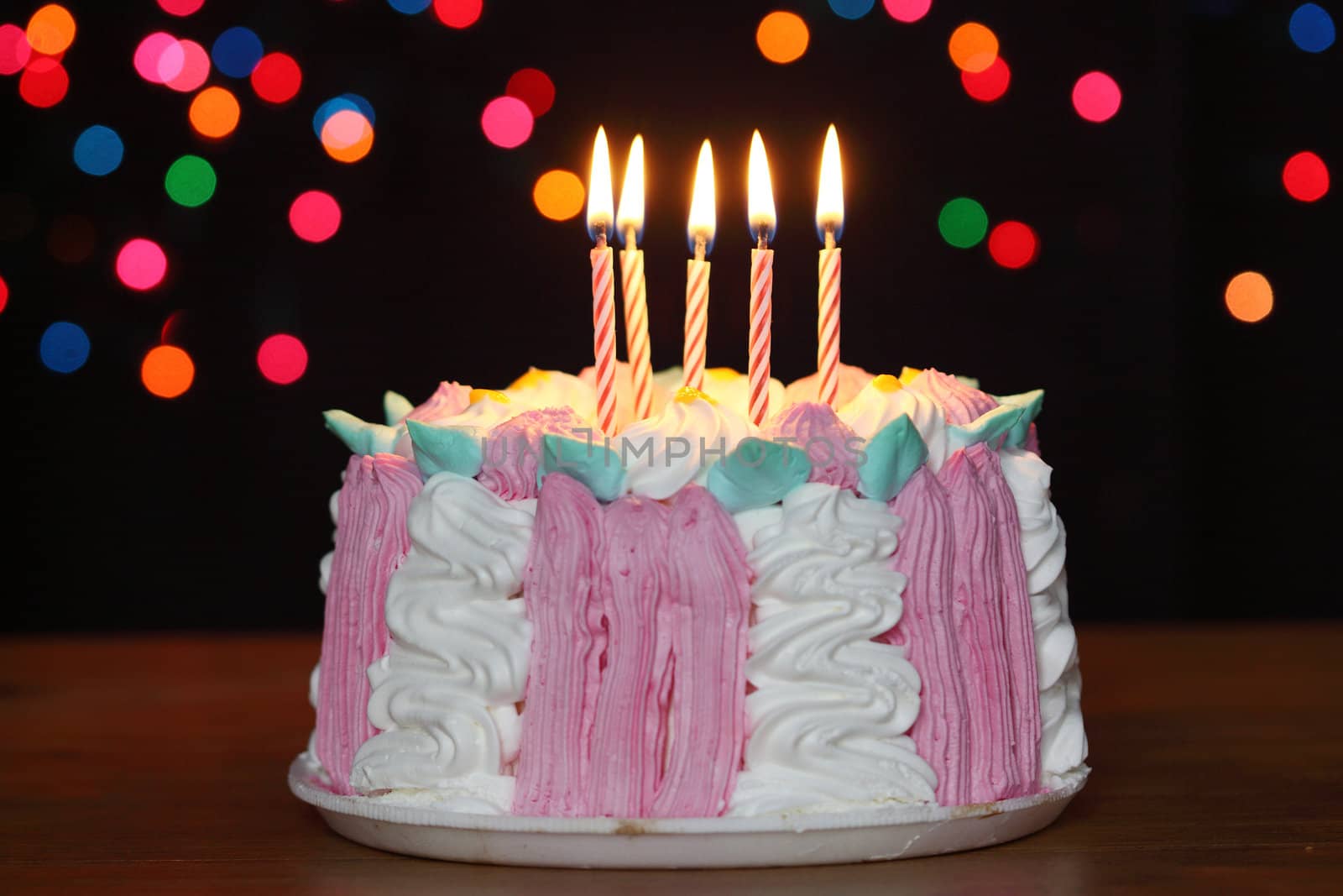 birthday cake with candles over black background