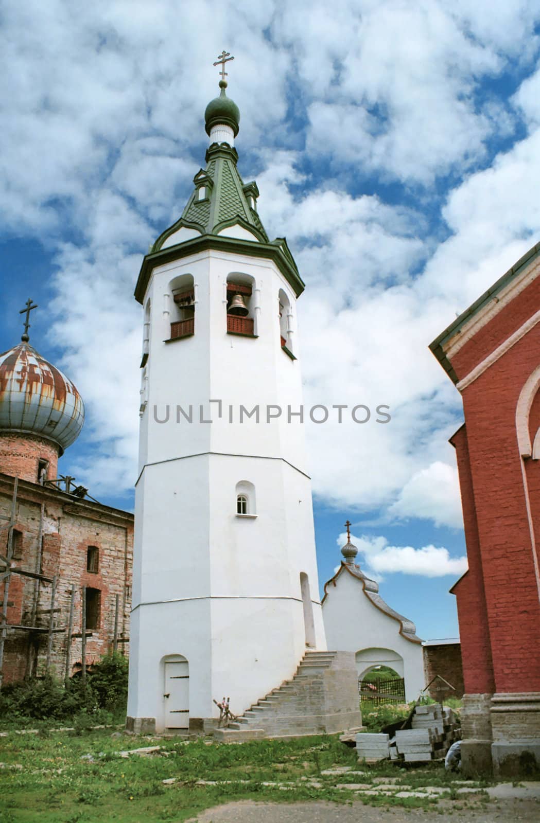 White bell tower in renovated monastery