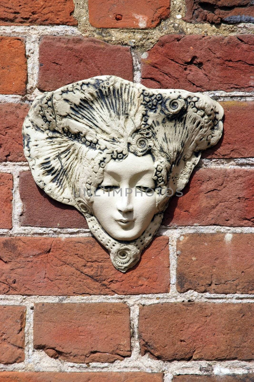 Decorative plant holder on a brick wall