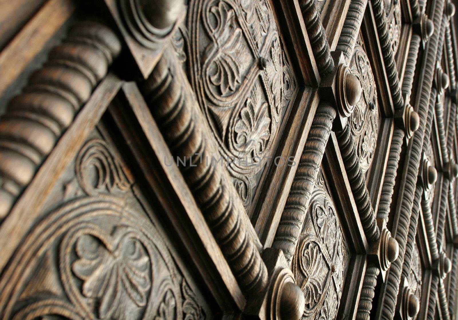 Detail from a beautiful wooden carved door of a church.