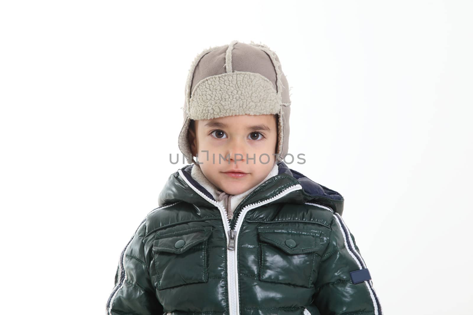 Child in winter clothes on white background