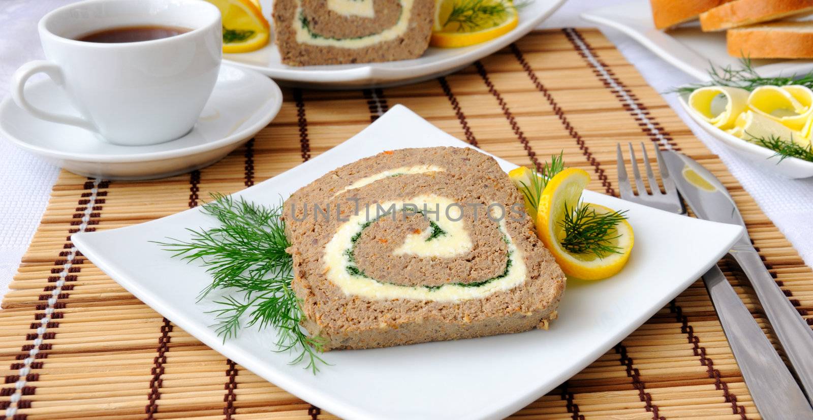 Slices of liver pate with butter and coffee for breakfast