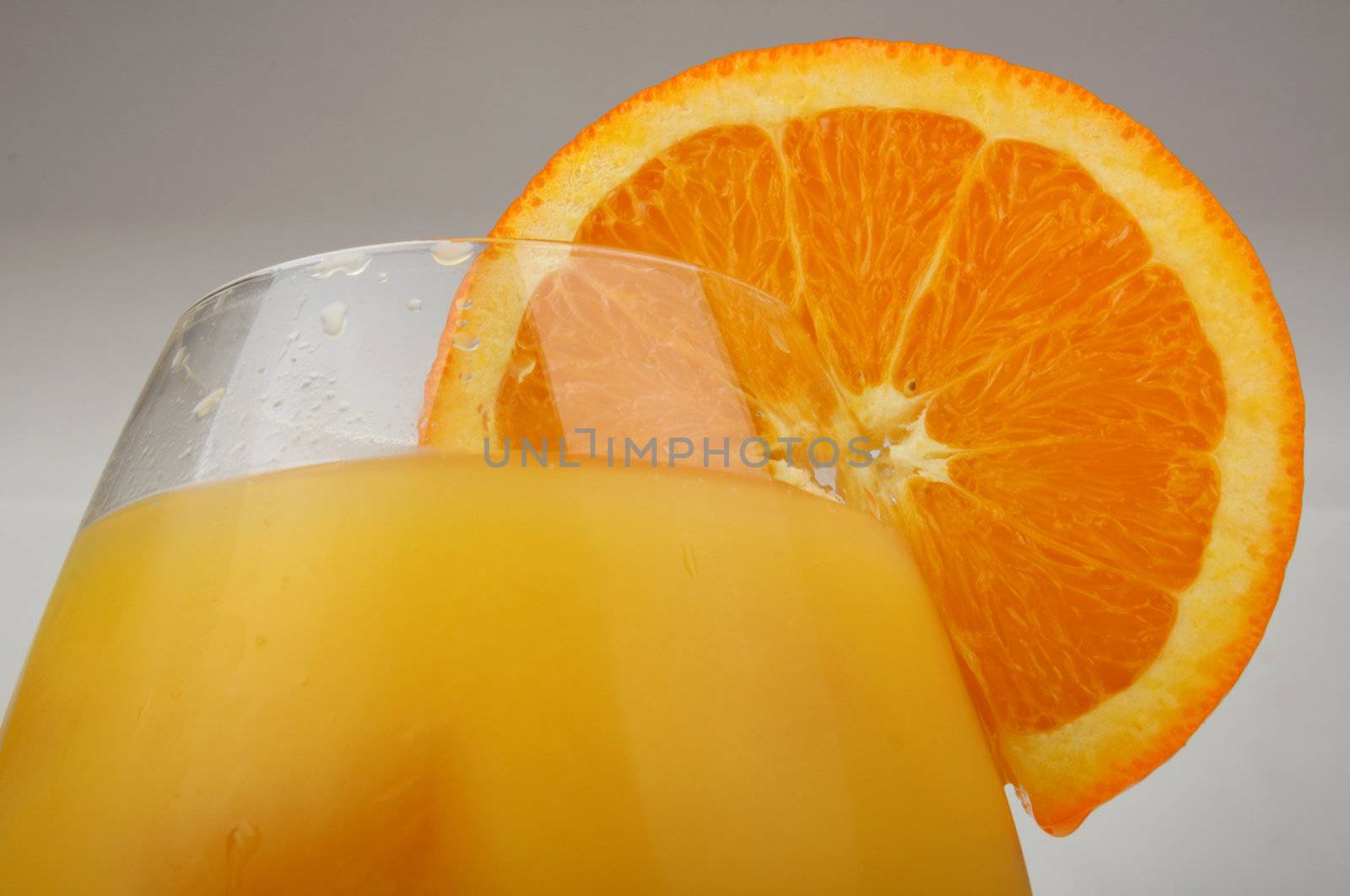 Glass of fresh orange juice with an orange slice