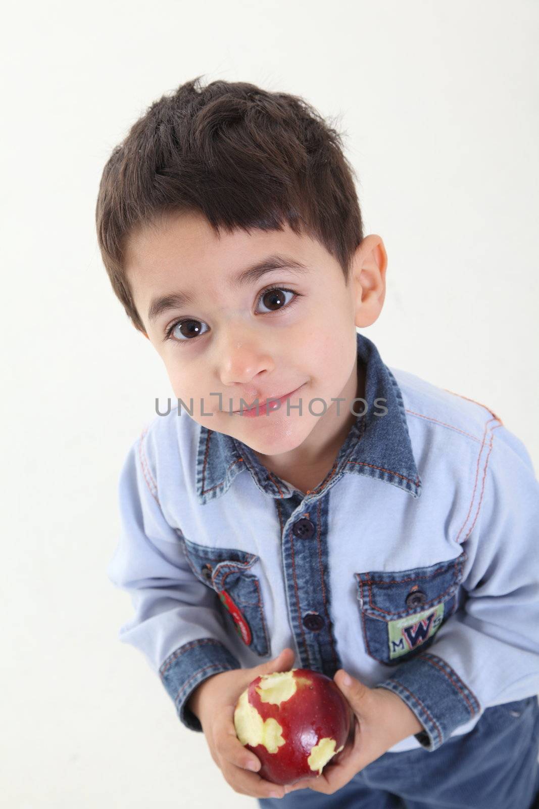 Child eating an apple on white background