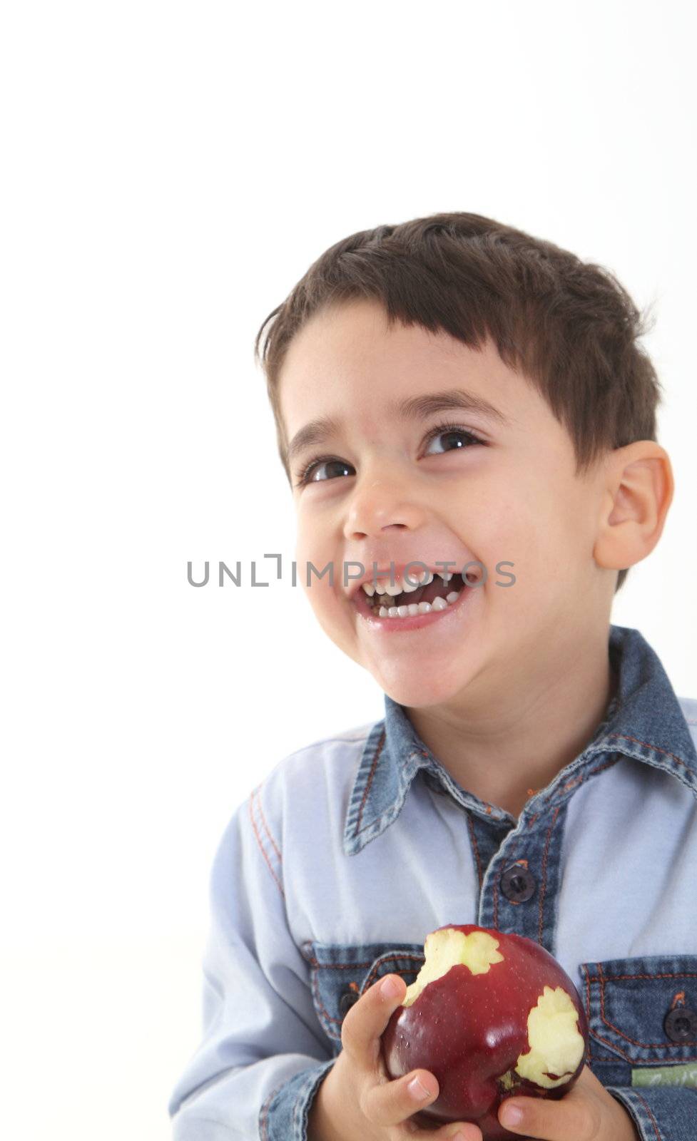 Child eating an apple on white background