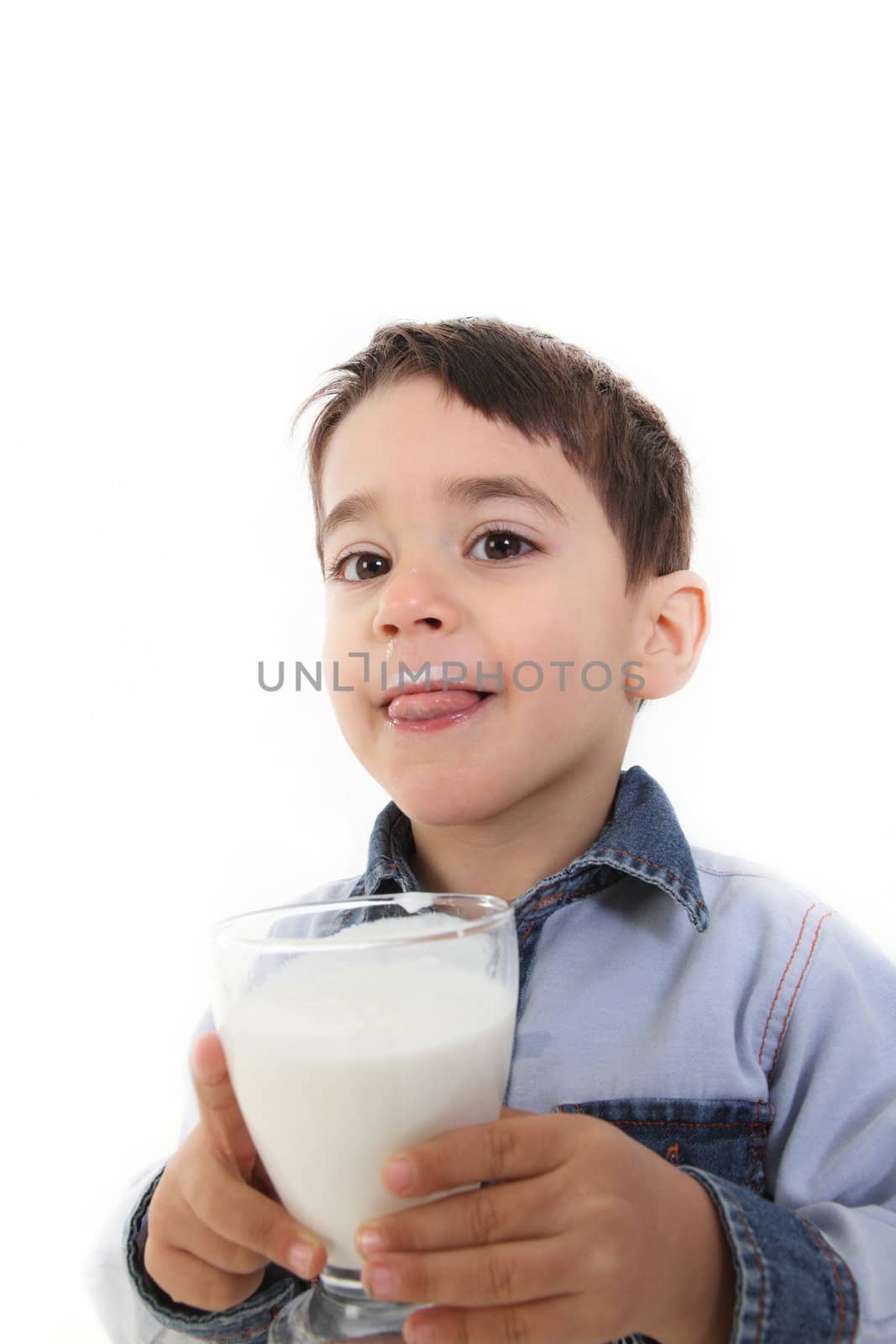 Handsome child drinking a glass of milk