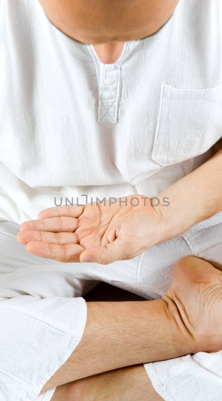 Man meditating hand by vilevi
