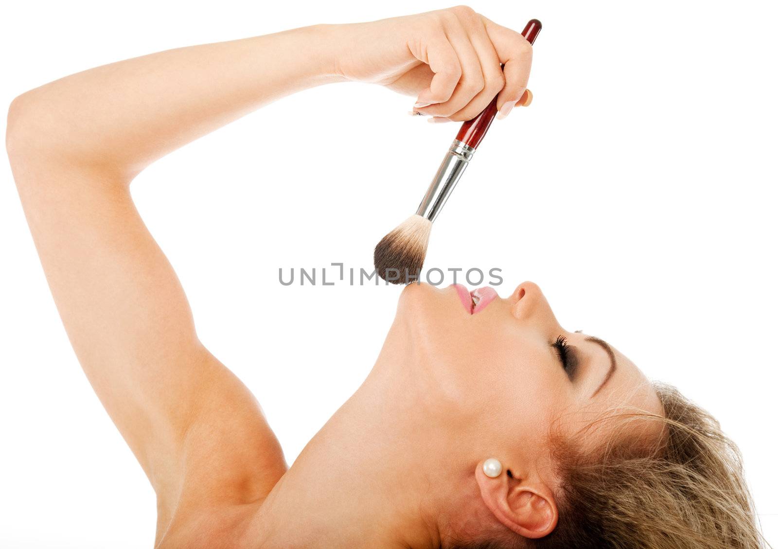 profile of a beautiful female holding a make-up brush