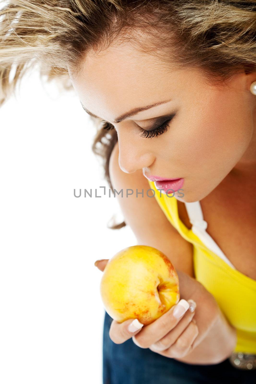 beautiful young sexy female is holding a juicy peach