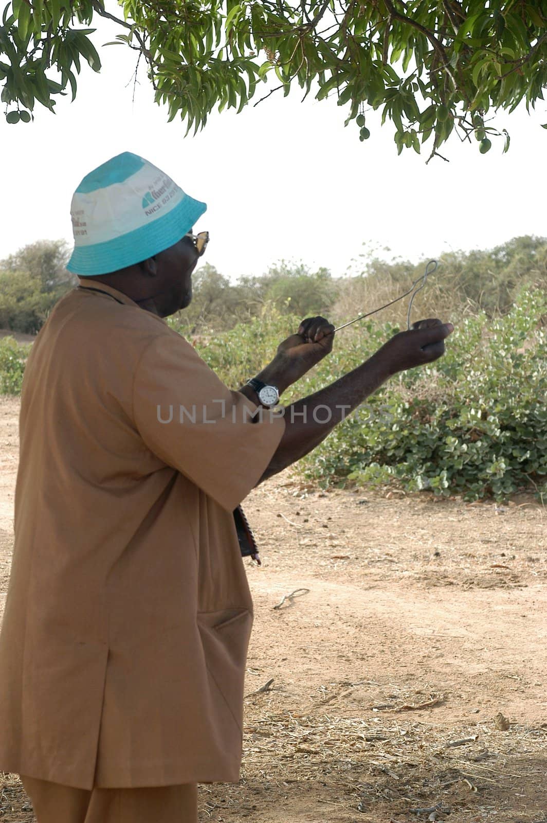 African waterfinder with work in an area of Burkina Faso Faso. Water is not rare in Africa, only it is necessary to drill wells to reach it. The waterfinder thus determines the place exact where to drill because drilling costs 8000 ? and it is not question of missing the place where the machines will have to work.