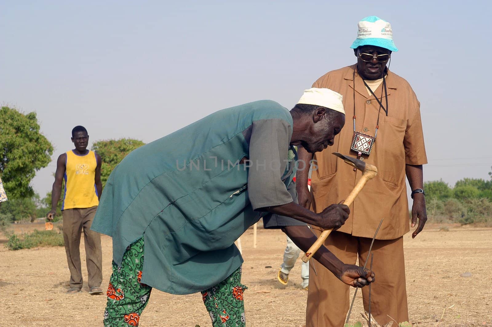 African waterfinder with work in an area of Burkina Faso Faso. Water is not rare in Africa, only it is necessary to drill wells to reach it. The waterfinder thus determines the place exact where to drill because drilling costs 8000 ? and it is not question of missing the place where the machines will have to work.