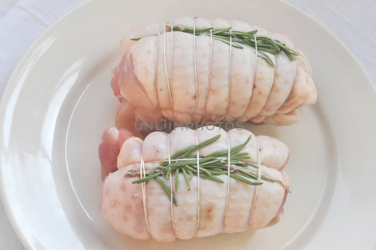 Chicken rolls with rosemary in a dish